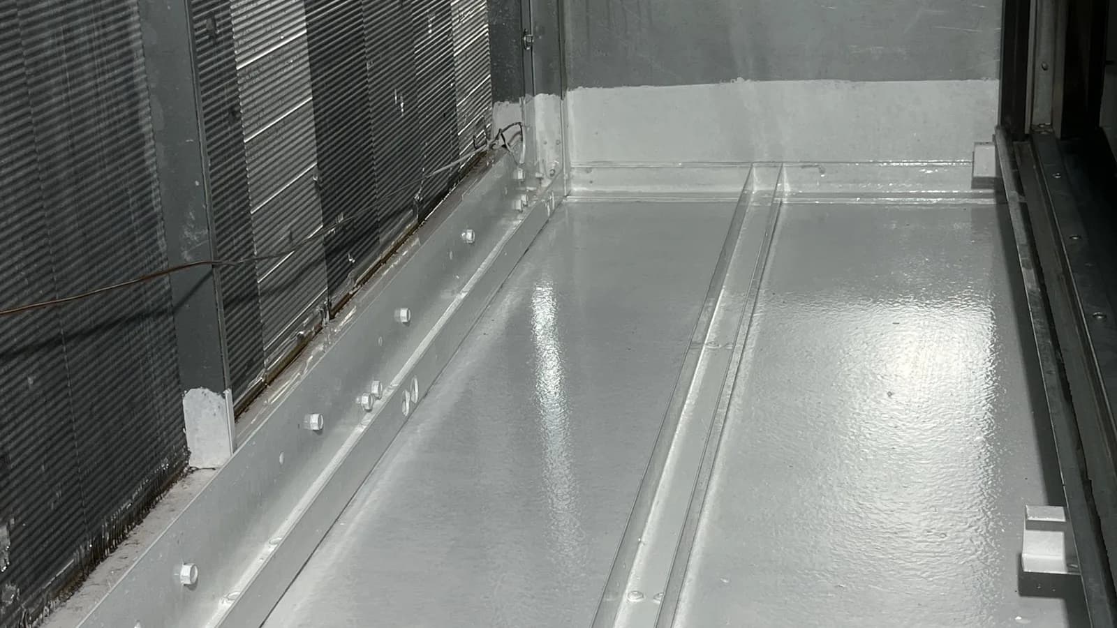 The coated interior wall beside the coil