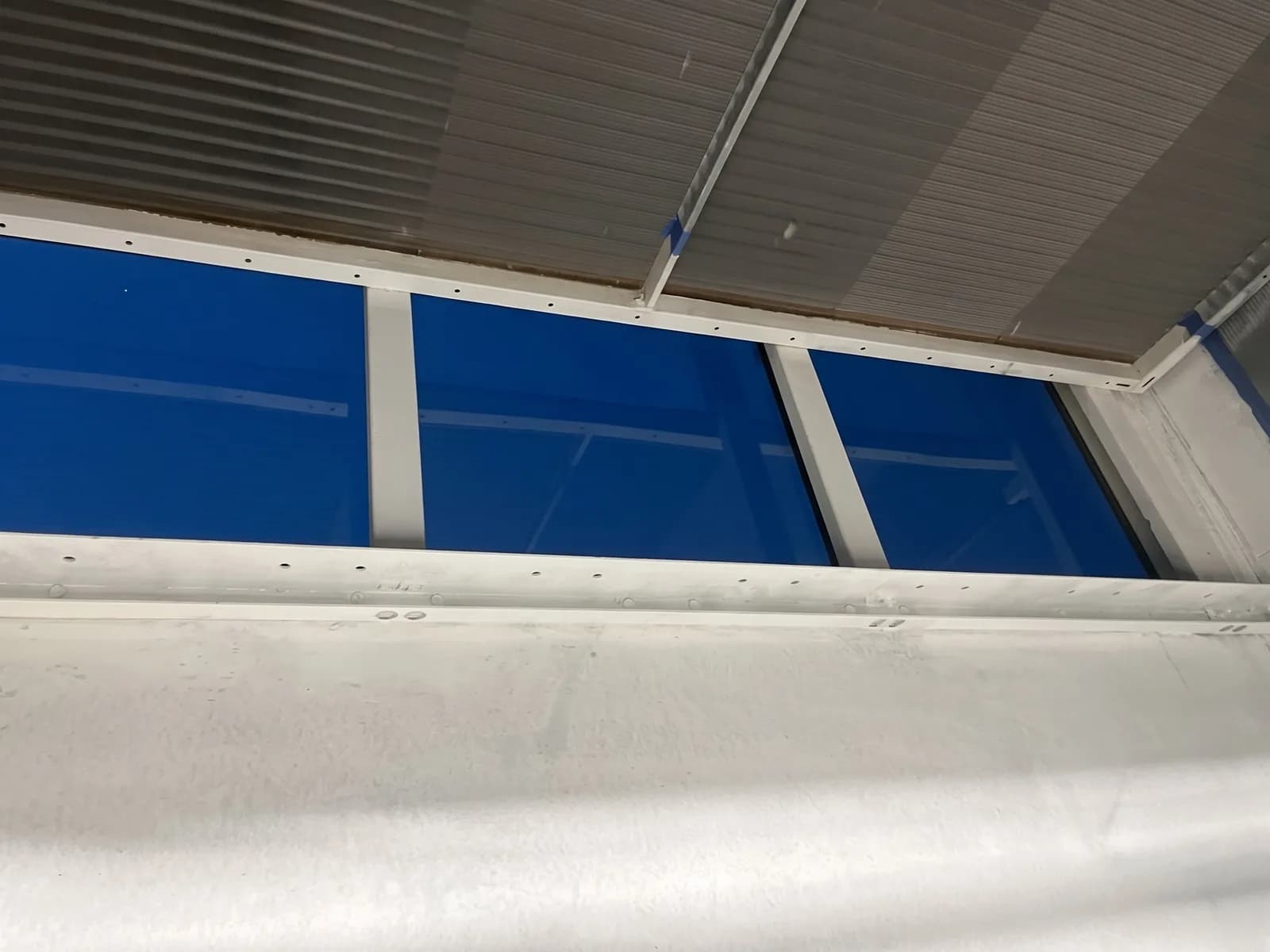 Coated pan sections beneath the coil
