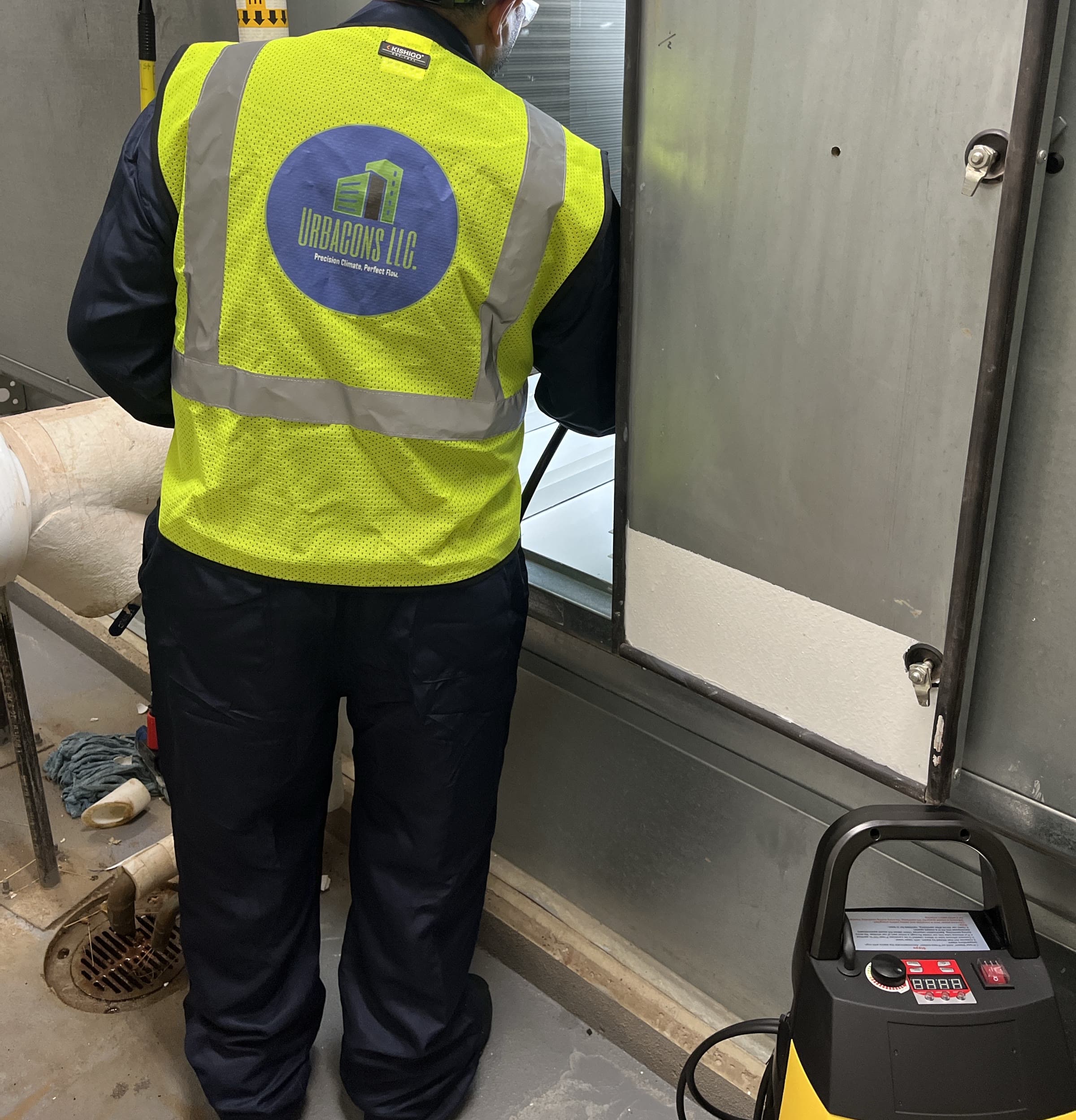 Urbacons technician accessing an air handling unit for condition assessment