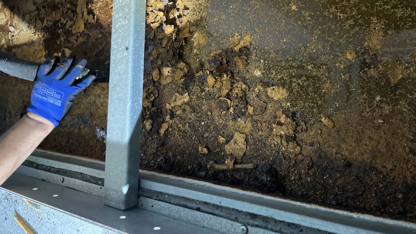 A corroded vertical interior surface, before work